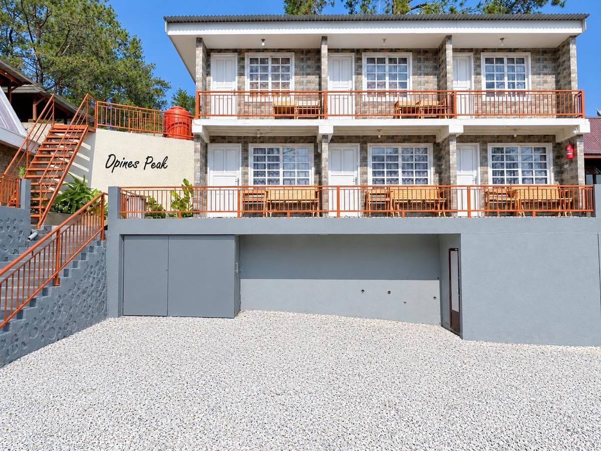 Villa Kotak, a two-storey stone-faced building with orange railings, at D'Pines Peak Villa Malino