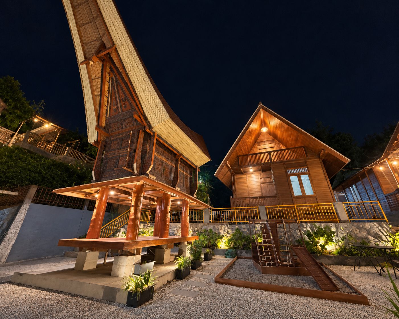Tongkonan house lit at night at D'Pines Peak Villa Malino
